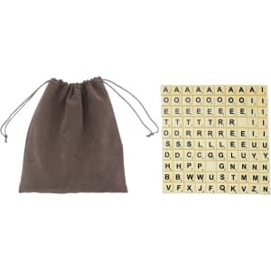 A brown drawstring bag next to a grid of beige letter tiles with black letters arranged in alphabetical order.