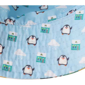 A light blue bucket hat featuring a playful penguin pattern and a logo on the inside edge.