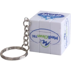 A small 3x3 puzzle cube keyring in white, featuring a metal chain attachment and a logo.