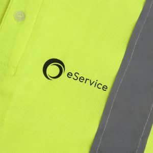 A bright yellow unisex polo shirt with reflective grey detailing and a logo on the front.