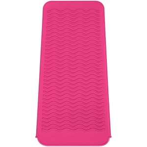 A pink heat-resistant silicone mat pouch with a textured wave pattern. It features a branding logo.