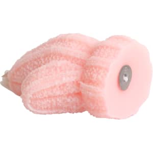 A pink glove-shaped candle with textured detailing and a metal base.
