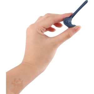 A hand holding a navy blue protective case for an Air Tag, featuring a sleek design and a loop for attachment.