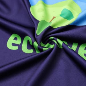 A close-up of a V-collar T-shirt in navy with a colourful design and a logo. The fabric is soft and textured.