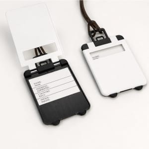 A set of ABS luggage tags in white and black, featuring a clear window and space for personal details.