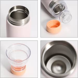 A drink bottle in light pink with a stainless steel interior and a removable orange lid, alongside a clear cup.