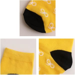 Yellow woven bamboo socks featuring a black heel and toe, with a repeating white pattern, alongside a logo.