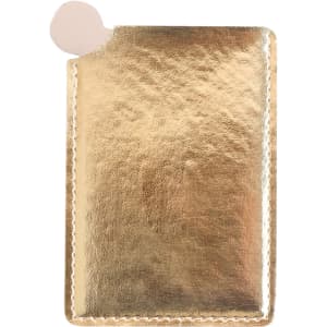 A gold portable mirror in a sleek, metallic case with a rounded edge and a small cutout for easy access.