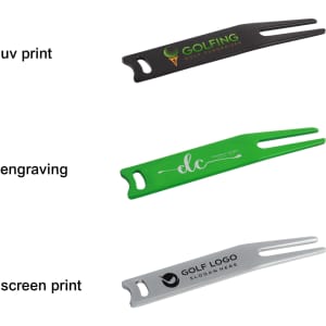 A set of three golf divot tools in black, green, and silver, each featuring a different brand logo or engraving.