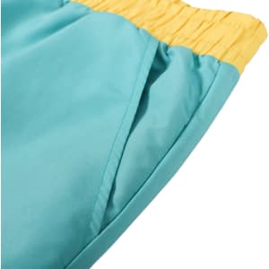 A pair of men's beach shorts in teal with a yellow elastic waistband and a side pocket.