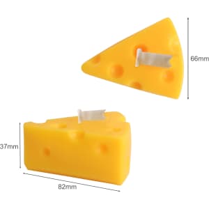 Triangle-shaped candles in a bright yellow hue, resembling cheese, with a small decorative flag on top.
