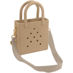 A tan mini beach bag with perforated detailing, featuring two handles and an adjustable shoulder strap.