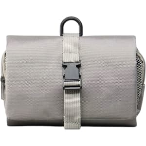 A grey folding travel toiletry bag with a strap closure and a hanging loop, featuring a textured fabric surface.
