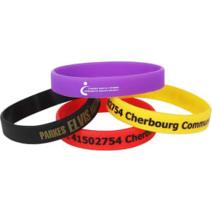 Four silicon wristbands in purple, yellow, black, and red, featuring a logo and printed text.