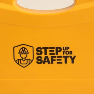 A yellow safety tool kit with a handle, featuring a logo and text related to safety.