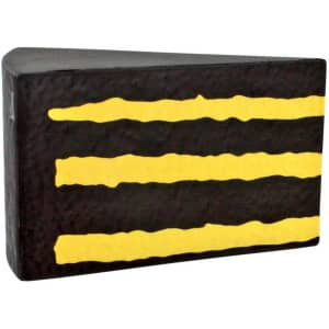 A chocolate cake-shaped stress reliever in black with yellow stripes, featuring a textured surface and a branding logo.