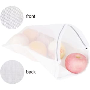 A white cotton mesh produce bag filled with apples, featuring a transparent design and visible branding.