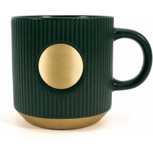 A ceramic coffee mug in dark green with a bronze circular accent and ribbed texture, featuring a logo.