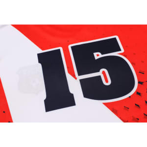 A red and white football jersey made of 100% polyester featuring the number 15 and a logo.