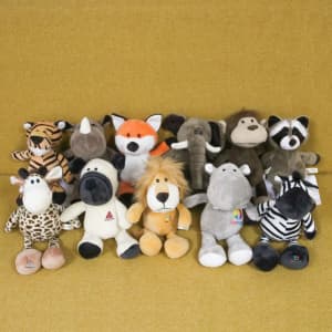 A set of plush toys featuring a raccoon, elephant, giraffe, zebra, lion, and more, in various colours and sizes.