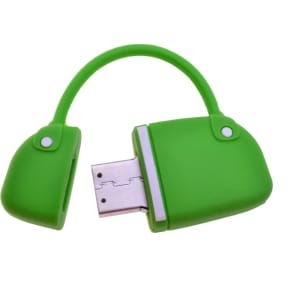 A green handbag-shaped flash drive with a USB connector exposed and a handle. It features two white buttons.
