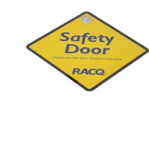 A yellow diamond-shaped warning sign with the text "Safety Door" and a logo, used for exhibitions and events.