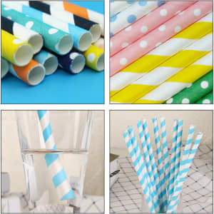 A collection of colourful 3-ply disposable paper straws in various patterns, including stripes and polka dots, with some in a glass of water.