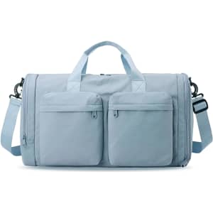A foldable travel duffle bag in light blue with two front pockets and a detachable shoulder strap.