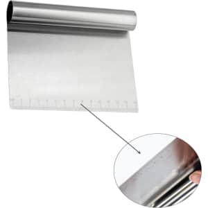 A stainless steel flour cutter with measurement markings along one edge, featuring a rounded handle.
