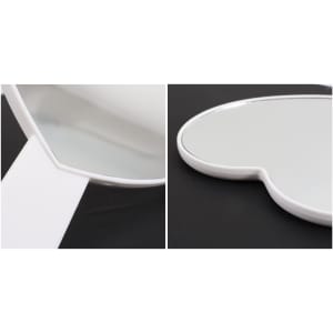 A heart-shaped handheld mirror with a white handle, featuring a smooth reflective surface.