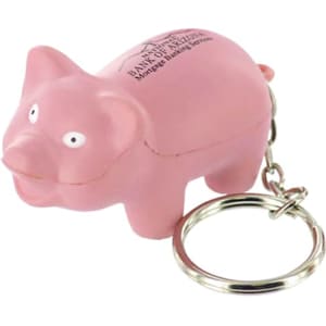A pink mini pig stress item attached to a keyring, featuring a small keychain and white eyes.
