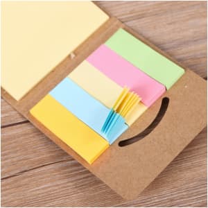 A mini sticky notes and flag set in various pastel colours, including yellow, pink, green, and blue, with a cardboard holder.