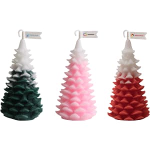 Cedar Christmas tree-shaped candles in green, pink, and red, featuring a decorative logo flag on each.