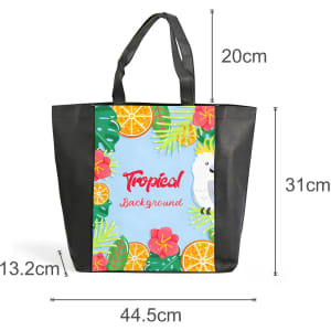 A tote bag with a full-colour tropical design featuring fruits, flowers, and a parrot, plus a black base and handles.