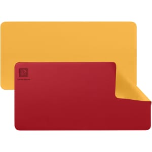 A PU leather desk mat in red and yellow, with a logo on one corner and a sleek, modern design.