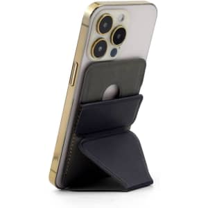 A black PU MagSafe phone stand card holder attached to a gold smartphone, featuring a built-in wallet.
