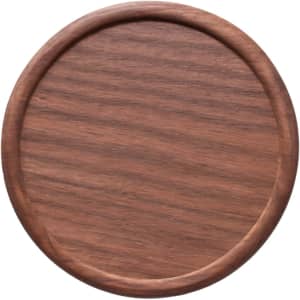 A round wooden coaster in a rich brown hue with a smooth finish and slightly raised edges.