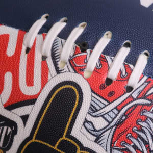 A training AFL ball in navy blue with red and white graphics, featuring stitching and a logo.