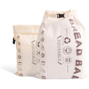 Two cream-coloured linen bread bags with drawstring closures, featuring various printed icons and a logo.