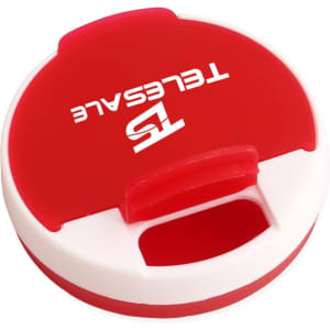 A round pill box in red and white, featuring a logo on the top.