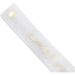 A sheer white organza ribbon featuring gold lettering and embellishments. Includes a heart design.