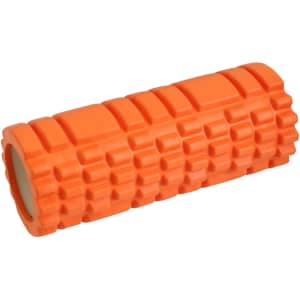 An orange foam yoga roller with a textured surface and a hollow centre. It has a simple logo on one side.