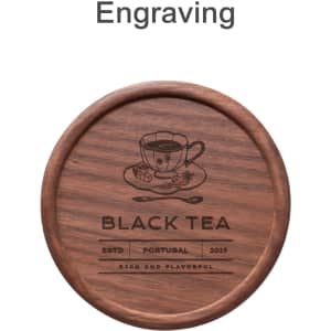 A round wooden coaster featuring an engraved design with a tea cup and branding elements. The colour is a rich brown.