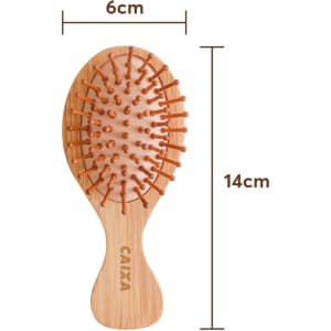 A small bamboo hairbrush featuring a wooden body and orange bristles, measuring 6cm by 14cm.
