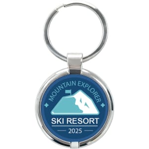 A round epoxy tag in blue and silver featuring a mountain graphic and a keyring attachment.