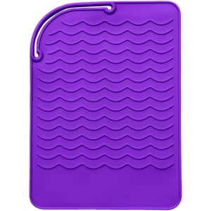 A purple silicone hair straightener pad with a textured wave design and a hanging loop.