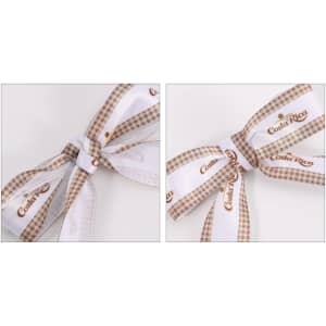 A set of two twist tie bows featuring a white and brown checkered design with branding.