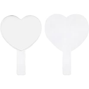 A heart-shaped handheld mirror with a transparent handle, featuring a smooth, reflective surface.