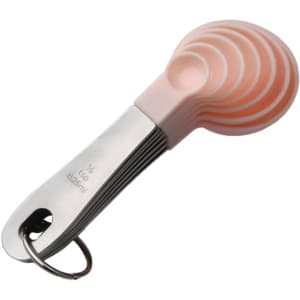 A set of pink silicone measuring spoons with a stainless steel handle, attached by a metal keyring.