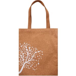 A cork tote bag in a natural brown colour featuring a white tree design and tan handles.